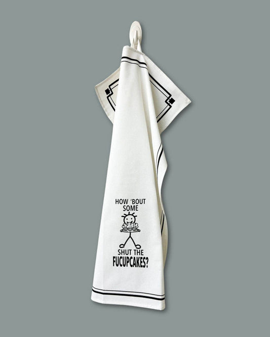 Kitchen towel with humorous text and graphic on a gray background