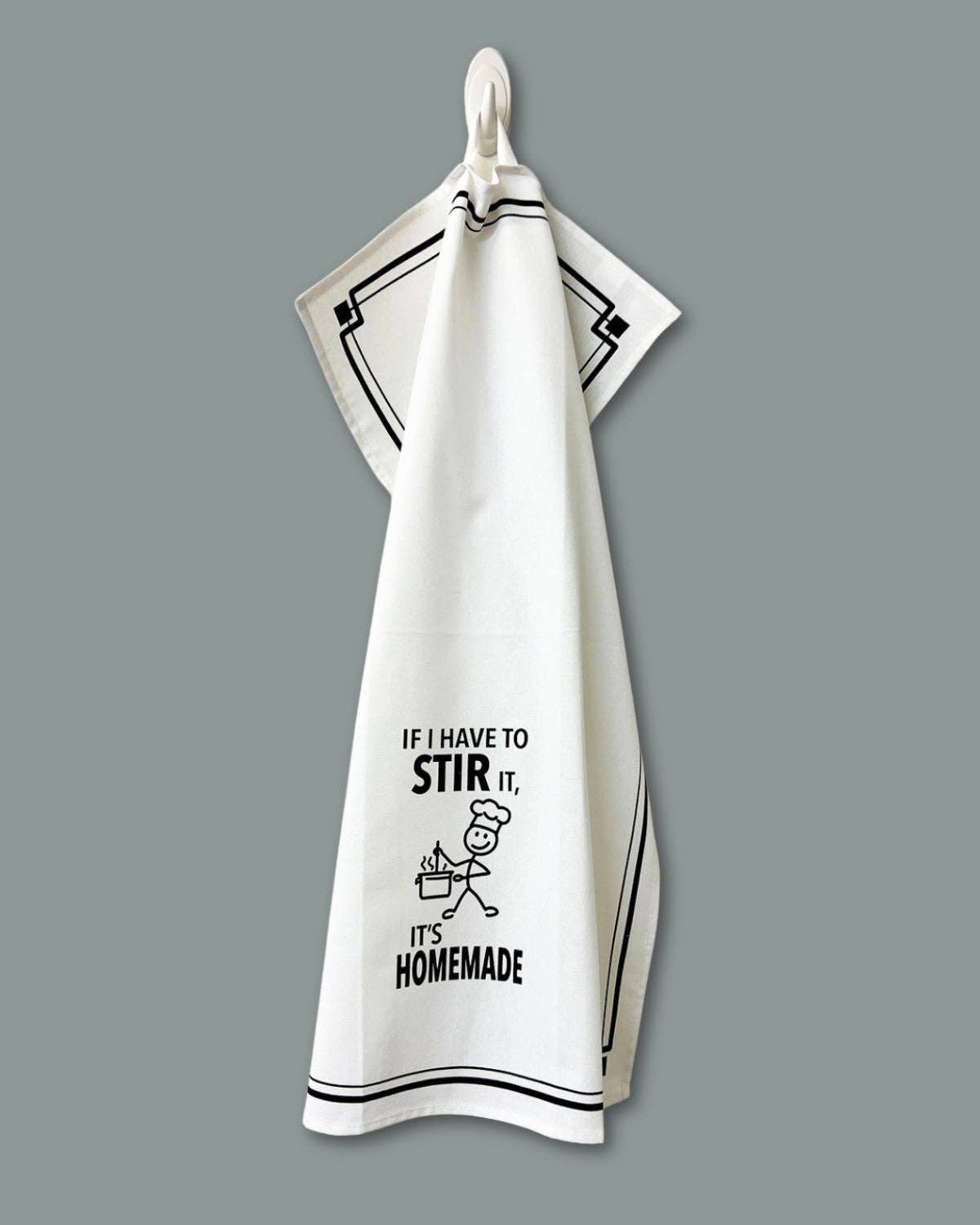 White towel with black text and graphic on a gray background
