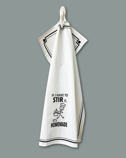 White towel with black text and graphic on a gray background