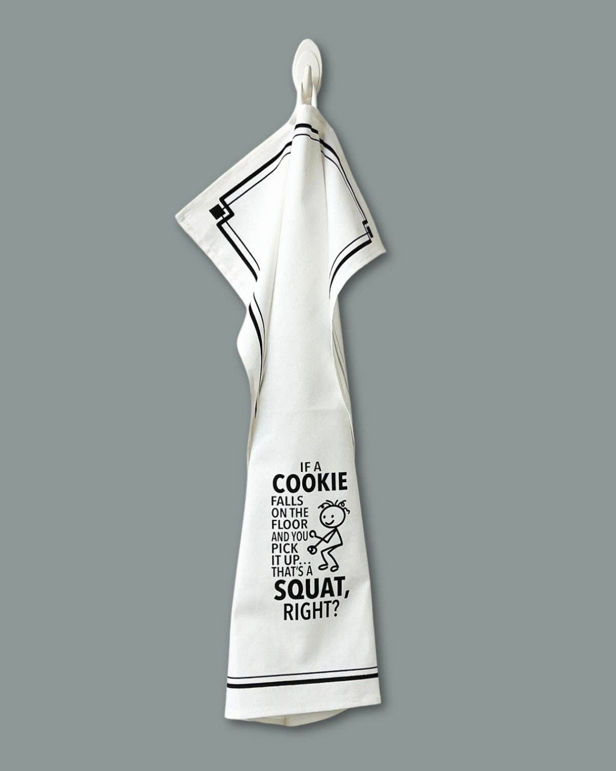 White towel with black text and graphic on a gray background