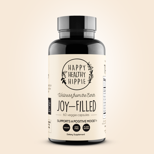Supplement bottle labeled 'Happy Healthy Hippie' on a beige background
