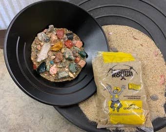 Black bowl with pet food and a package of Weruva cat food on a concrete surface