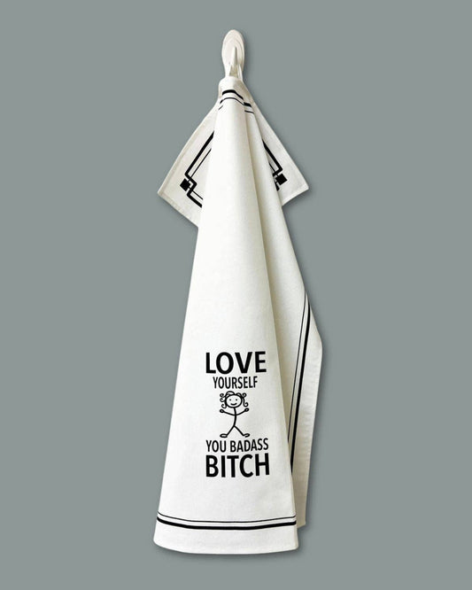 White towel with black text and design on a gray background