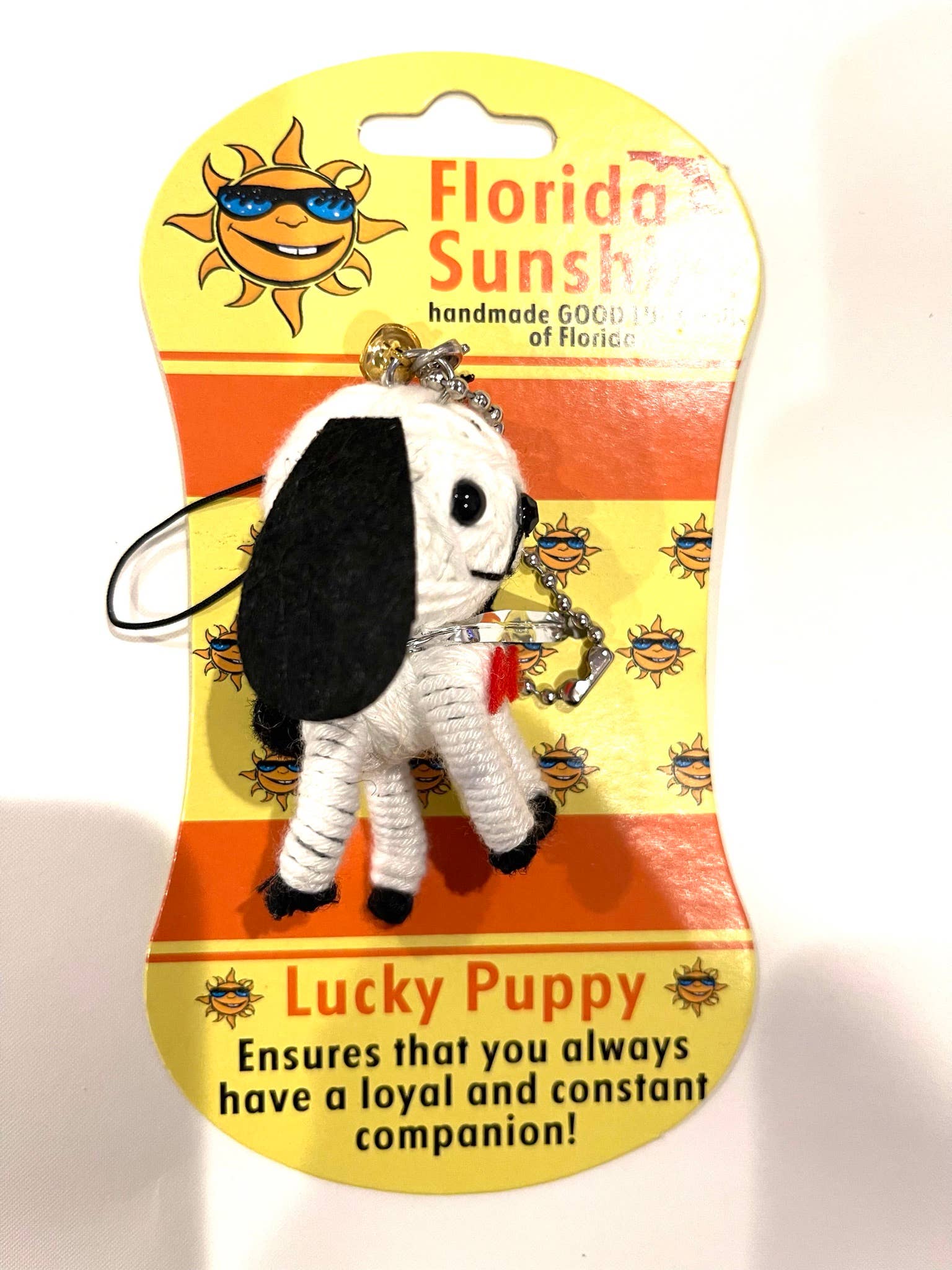 Lucky Puppy keychain on a Florida Sunsh packaging with text and sun graphics.