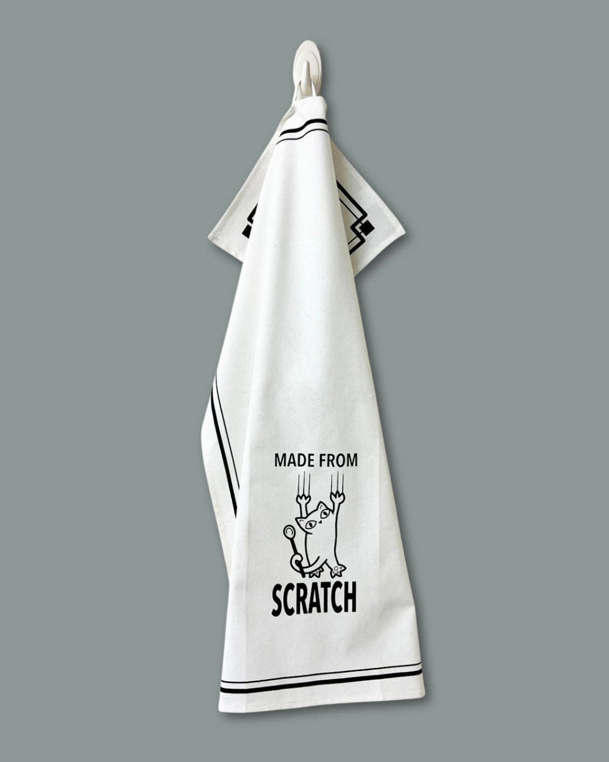 White towel with black text and graphics on a gray background