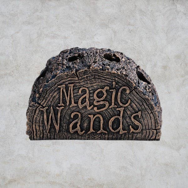 Decorative stone shelf with 'Magic Wands' text on a textured surface
