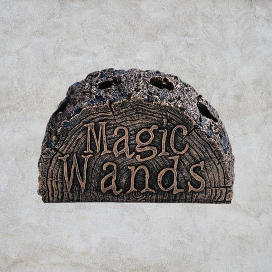 Decorative stone shelf with 'Magic Wands' text on a textured surface