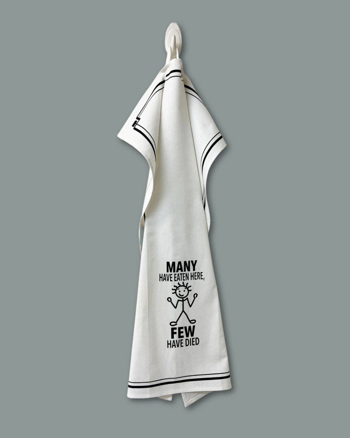 White towel with black text and design on a gray background