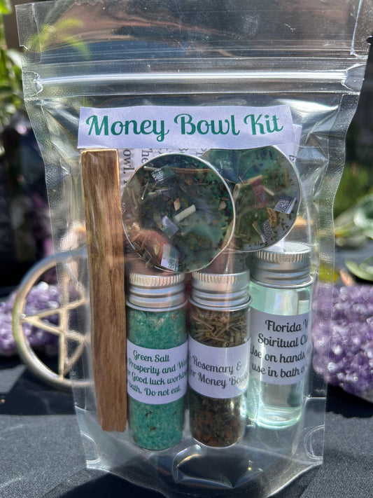 Money Bowl Kit with various items including a stick, bottles, and a label on a reflective surface.