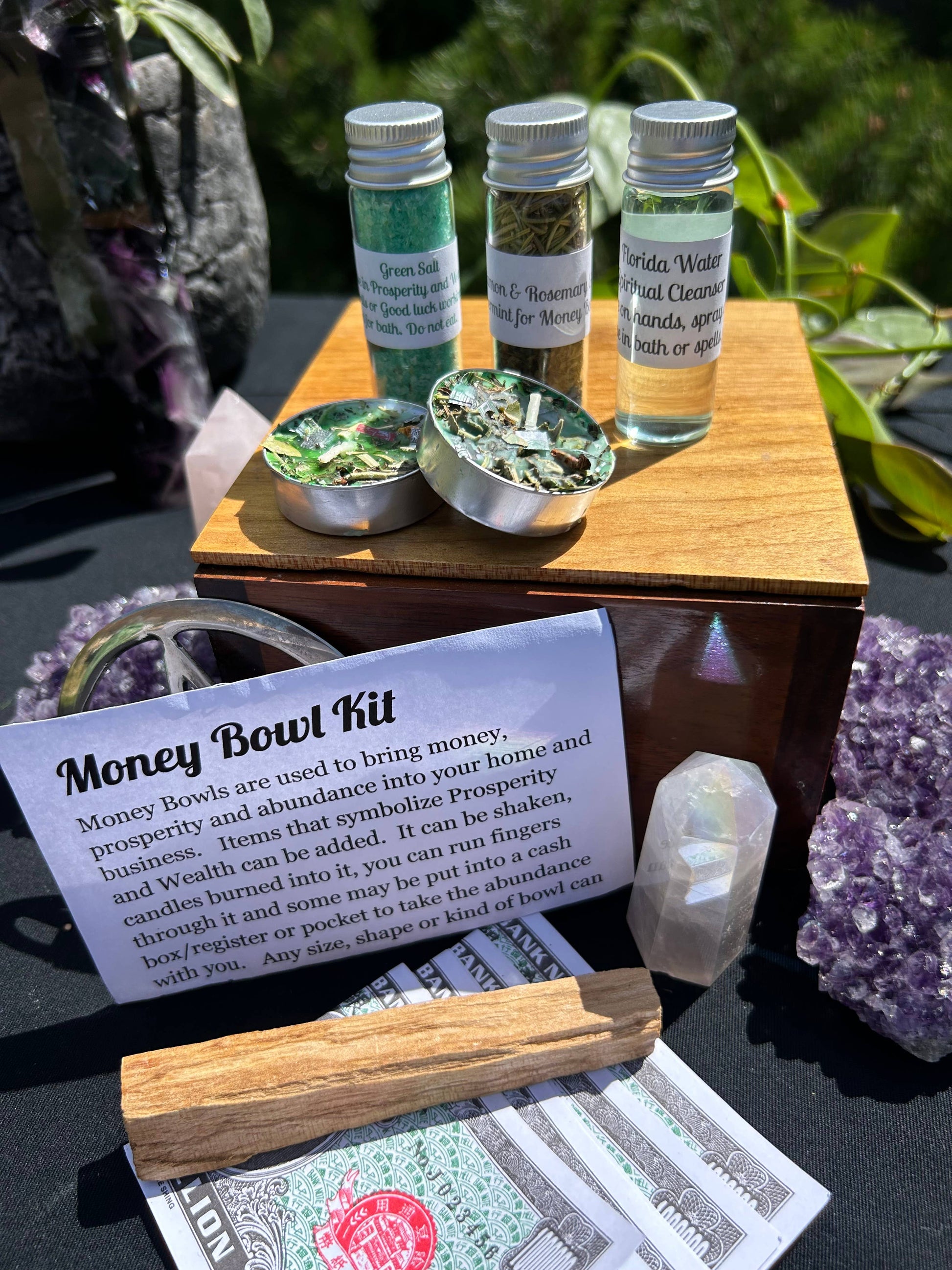 Money Bowl Kit with bottles, bowls, and a card on a table with crystals.
