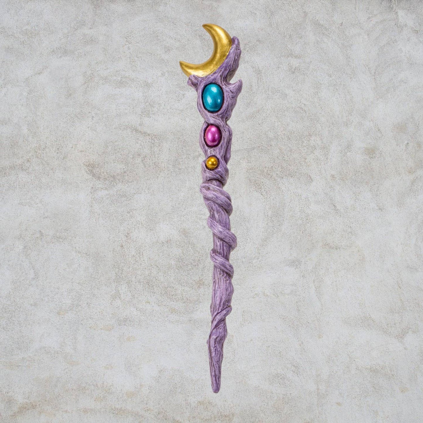 Fantasy staff with colorful gemstones on a textured beige background