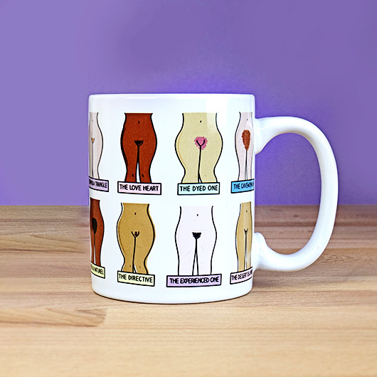 Mug with illustrations of different body parts and text on a wooden surface with a purple background