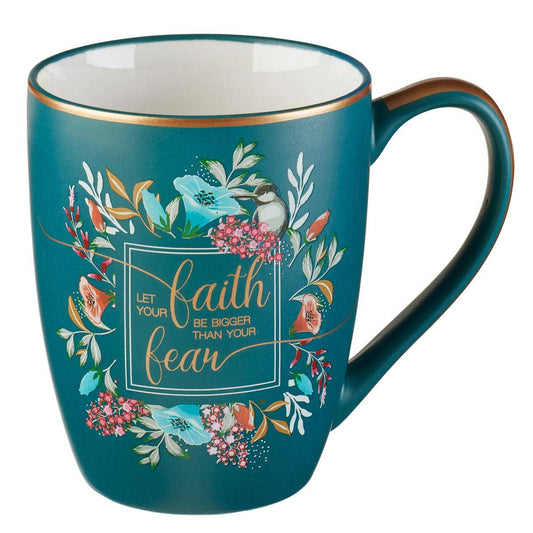 Teal mug with floral design and motivational quote on a white background