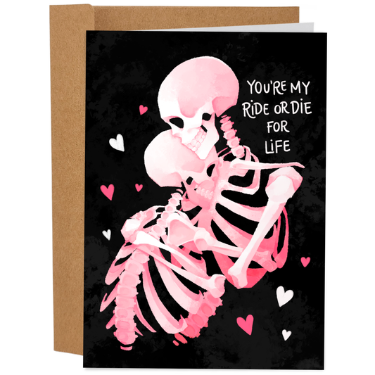 Greeting card with a pink skeleton and hearts on a black background, featuring text 'You're my ride or die for life'.
