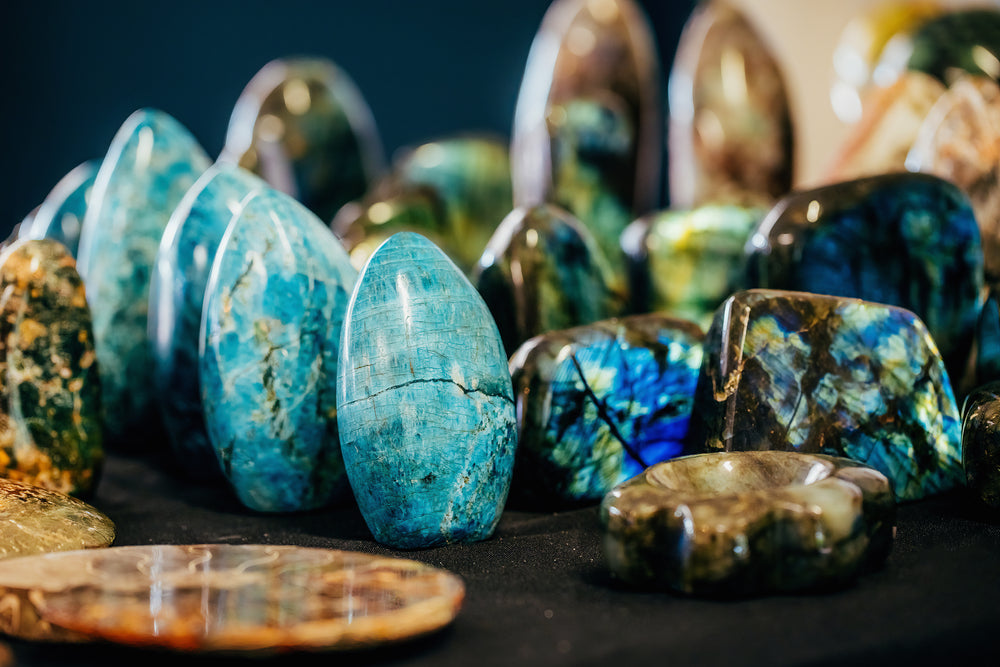 Collection of colorful gemstones on a dark surface