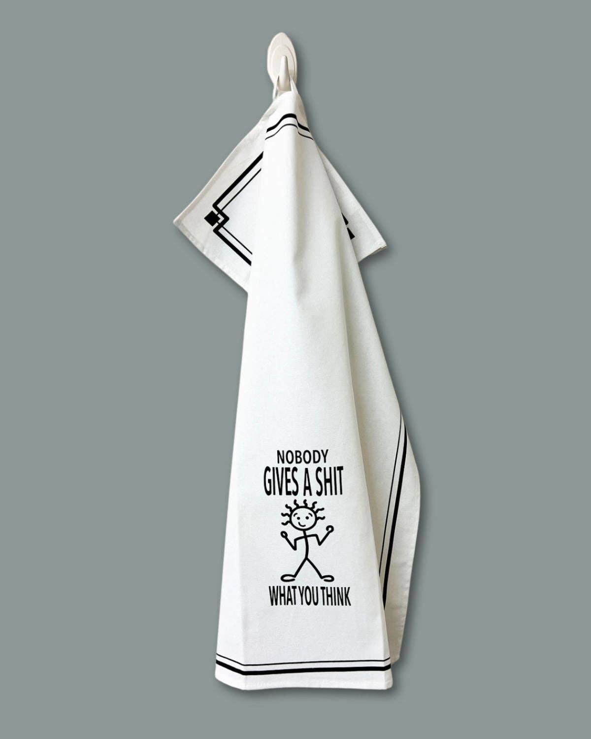 White towel with black text and graphic on a gray background