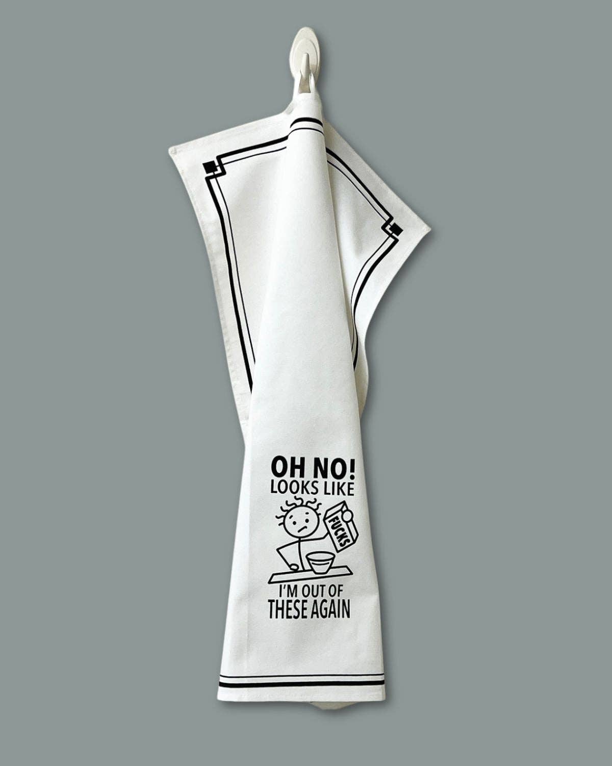 White towel with black text and graphics on a gray background