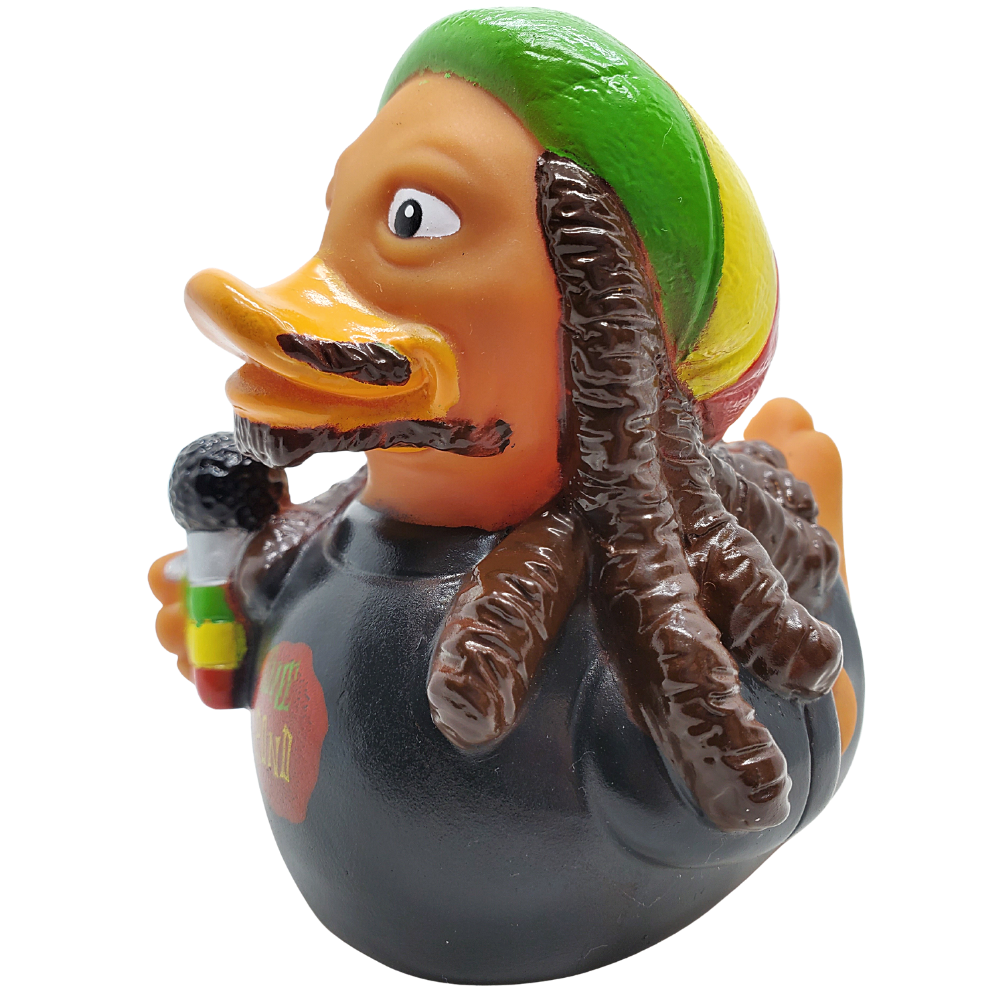 Rubber duck with reggae-themed accessories on a white background