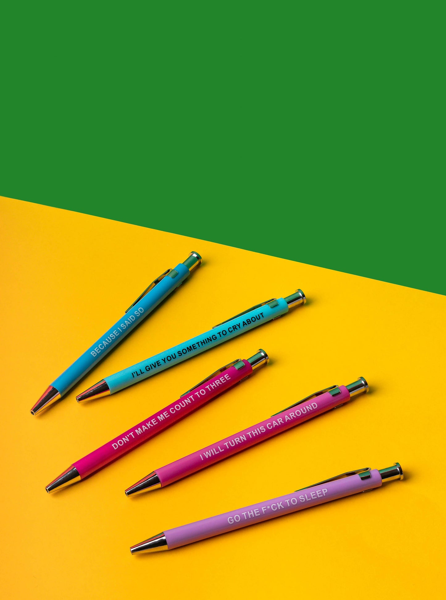 Four pens with humorous text on a yellow and green background