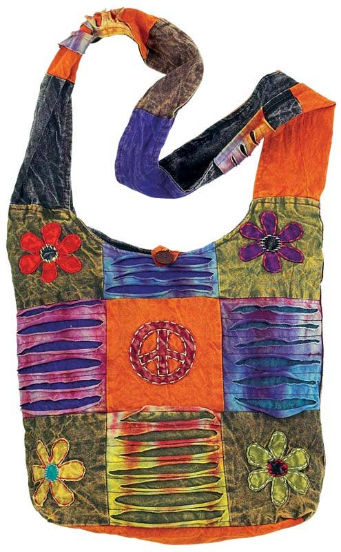 Colorful patchwork bag with floral and peace symbol designs on a white background