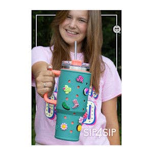 Child holding a colorful water bottle with floral designs outdoors