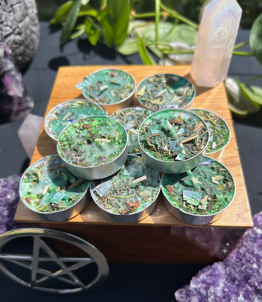 Set of small round containers with green and brown contents on a wooden board, surrounded by crystals and plants.