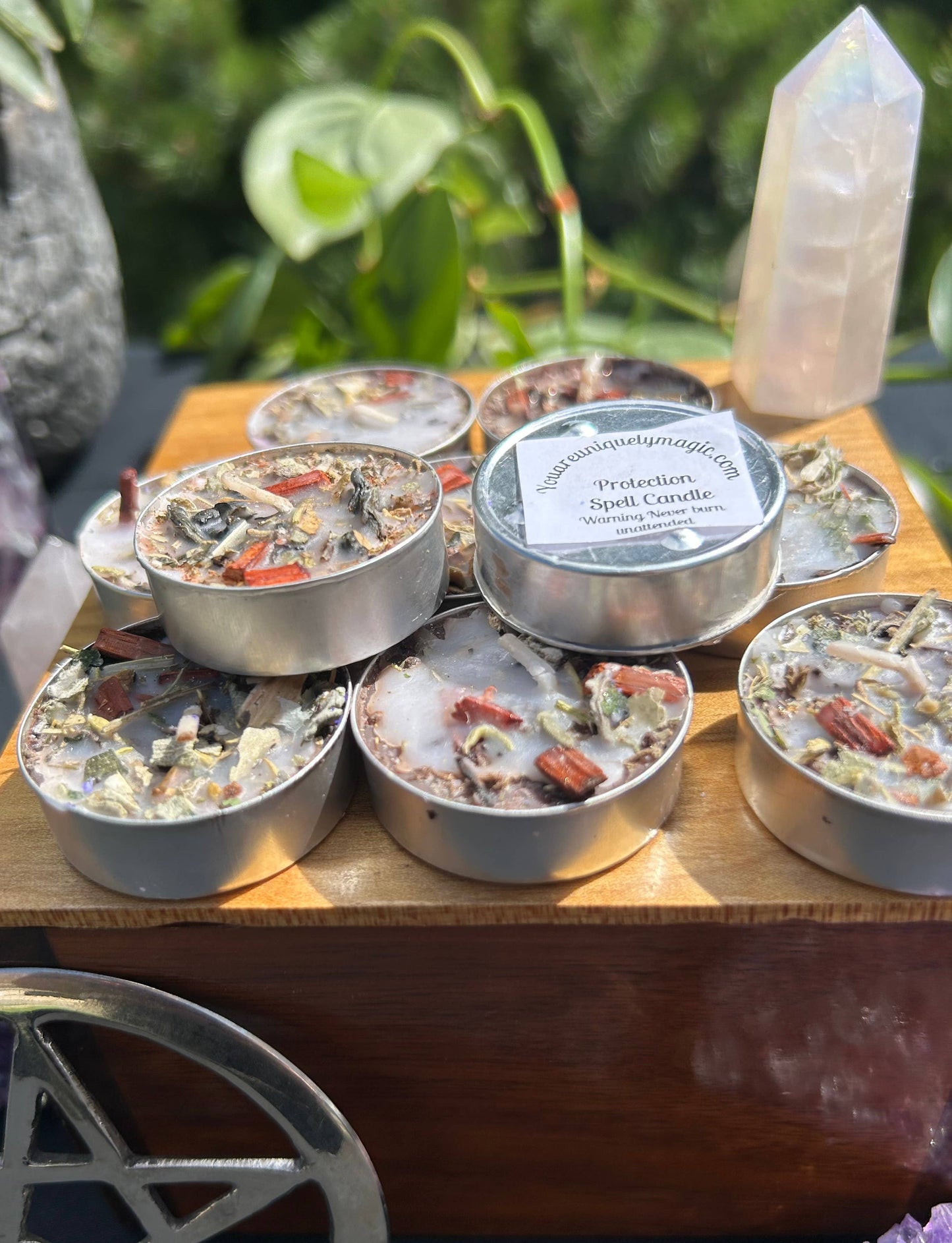 Collection of small candles on a wooden surface with a label and natural background