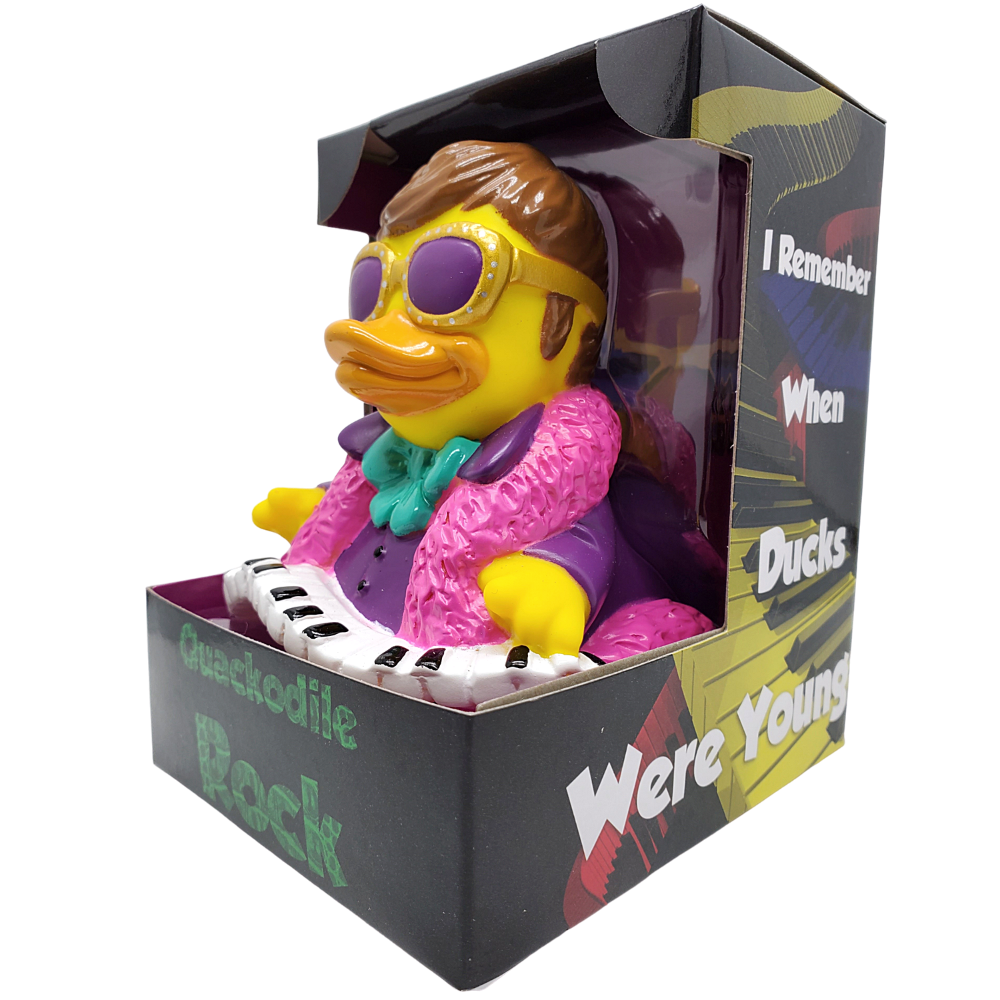 Toy duck with sunglasses and pink outfit playing keyboard in packaging with humorous text.
