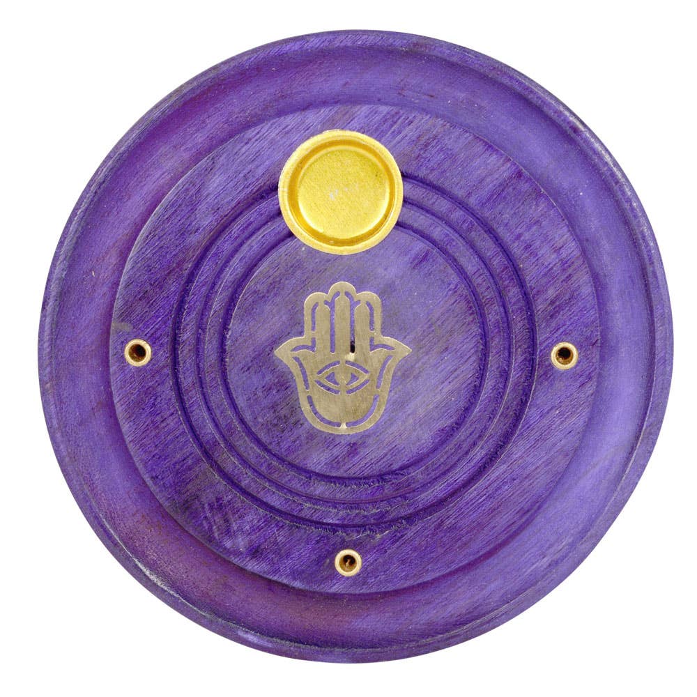 Purple circular object with gold Hamsa hand and eye symbol on a white background
