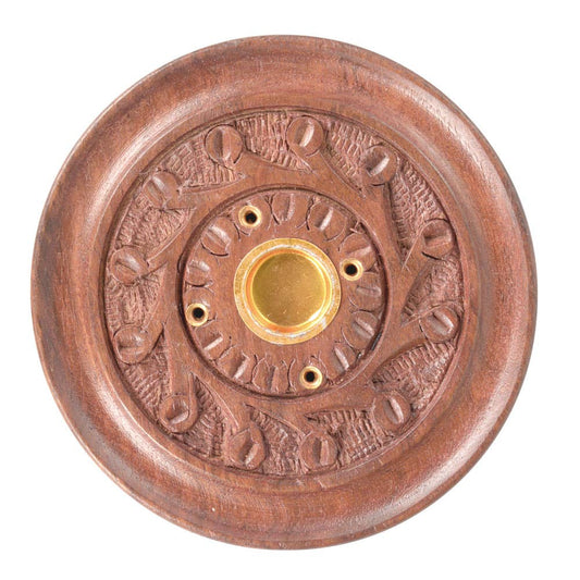 Decorative copper doorbell with embossed design on a white background