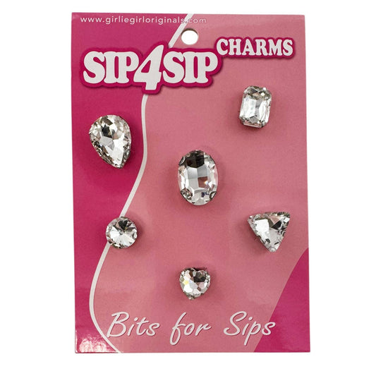 Packaging of Sip4Sip charms with clear gemstones on a pink background
