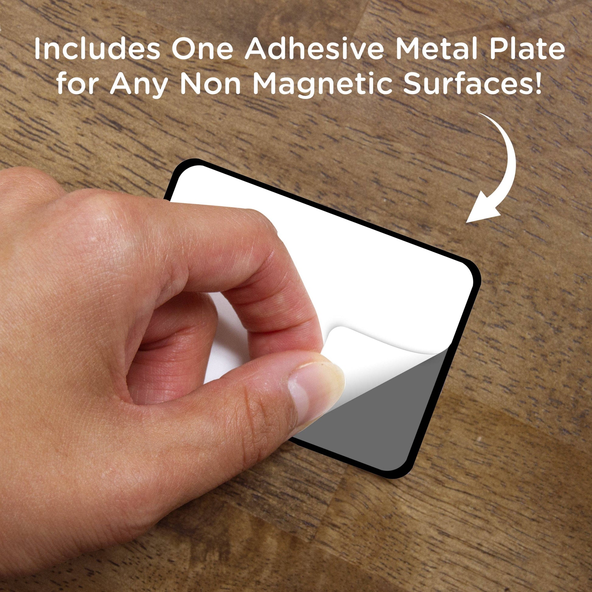 Hand holding an adhesive metal plate on a wooden surface with text about its use.