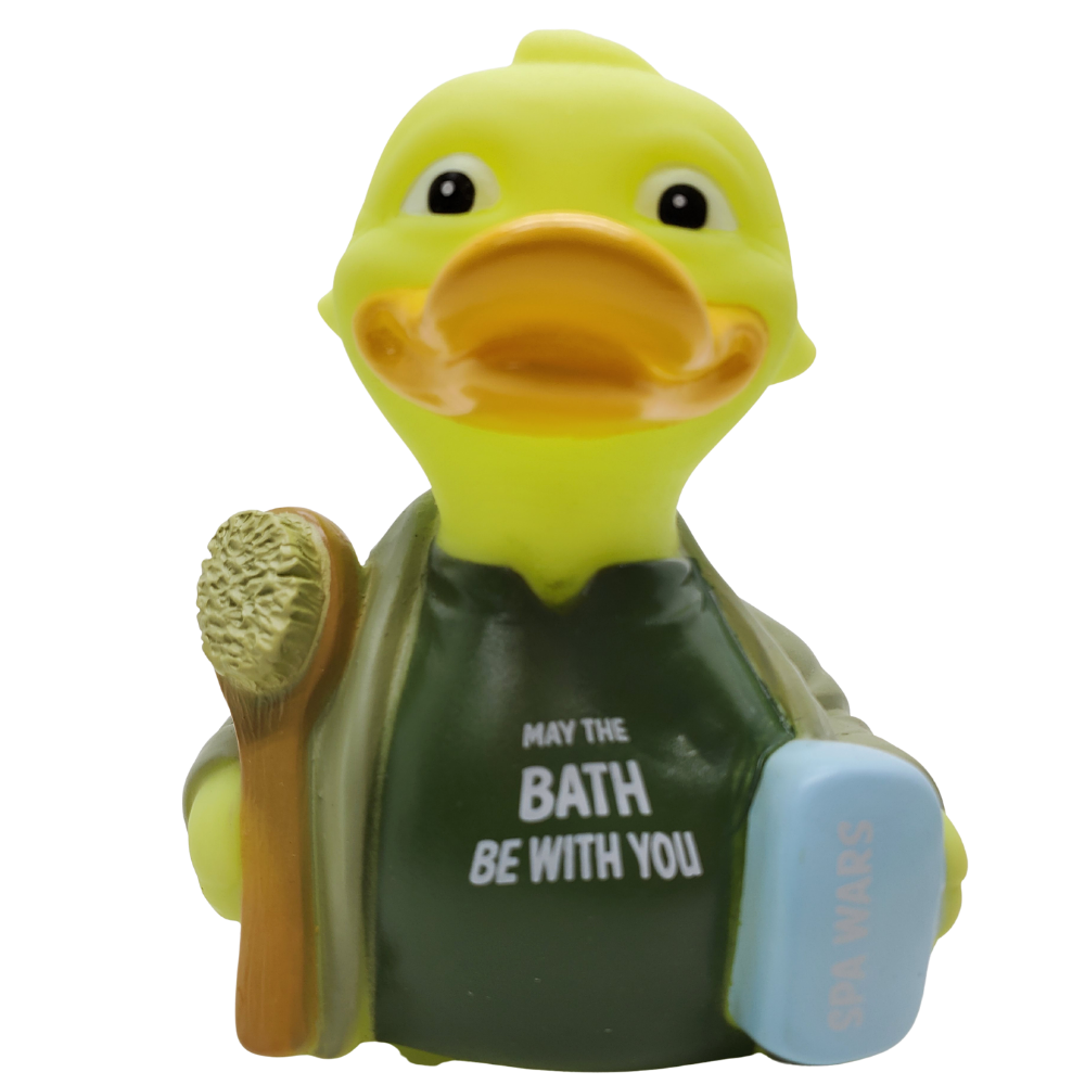 Yellow rubber duck with a towel and bath products on a white background