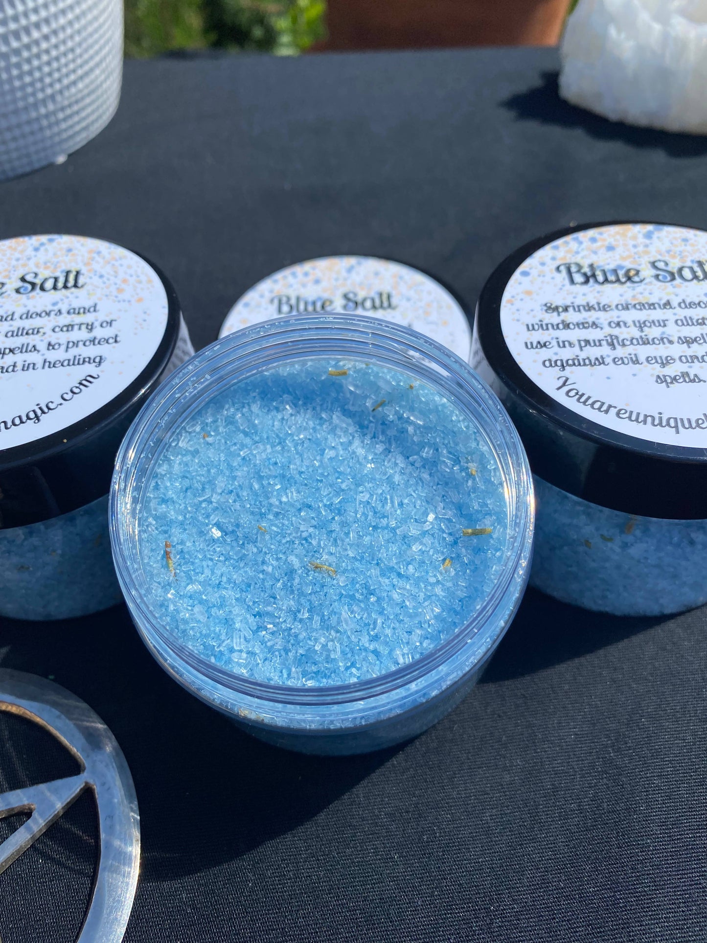 Container of blue salt with 'Blue Salt' labels on a dark surface
