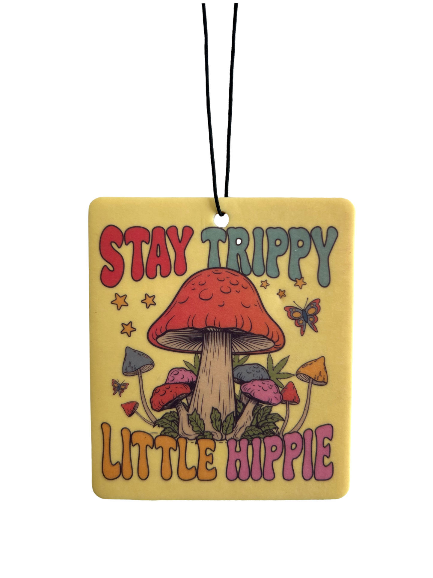 Decorative tag with mushrooms and text 'Stay Trippy Little Hippie' on a yellow background.
