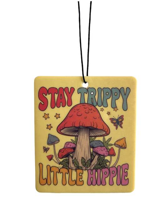 Decorative tag with mushrooms and text 'Stay Trippy Little Hippie' on a yellow background.