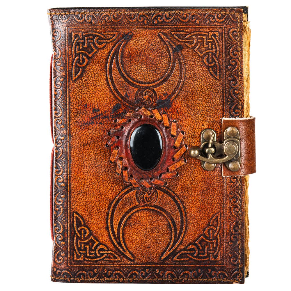 Decorative leather journal with embossed designs and a latch on a white background