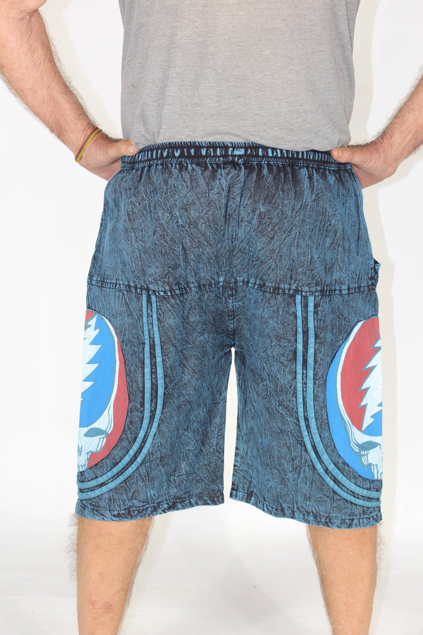 Blue denim shorts with a circular design on a white background