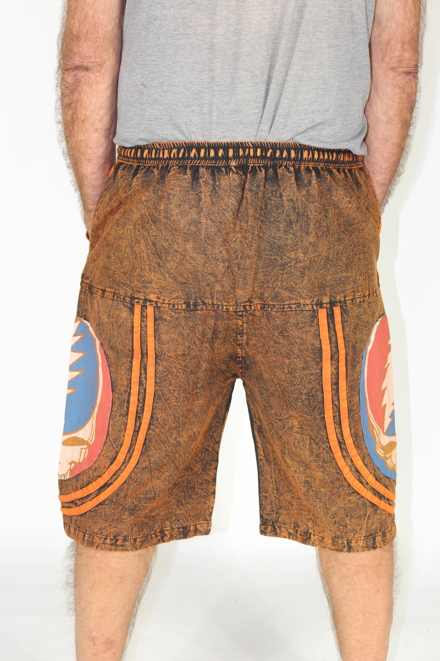 Brown shorts with colorful designs on a white background