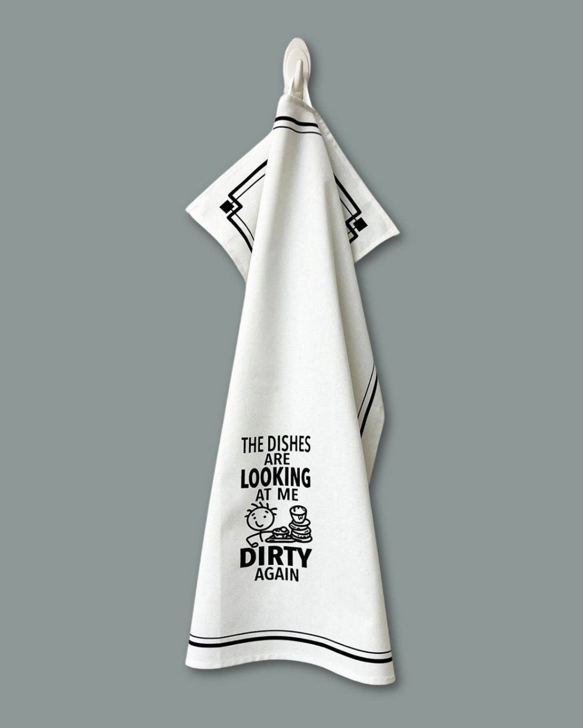White towel with black text and design on a gray background