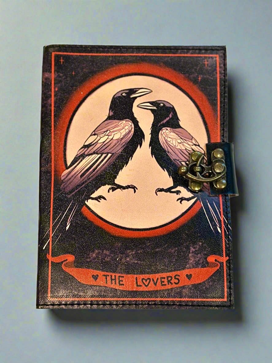 Small book with raven illustration and 'The Lovers' text on a light blue background