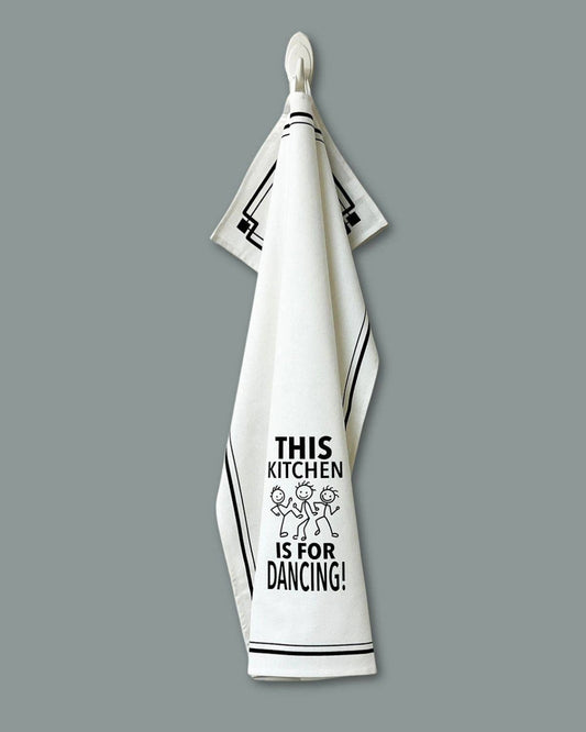 White kitchen towel with black text and graphics on a gray background