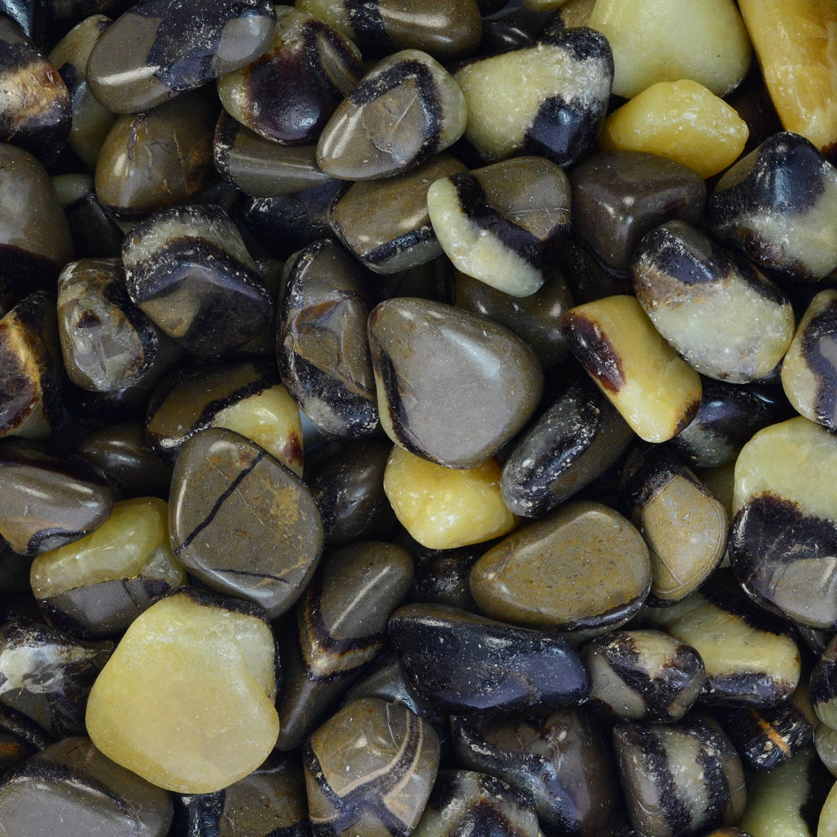Close-up of multicolored pebbles with shades of brown, yellow, and black.