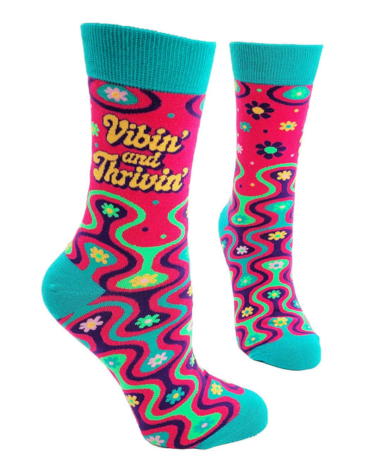 Colorful socks with 'Vibin' and Thrivin' text and floral patterns on a white background