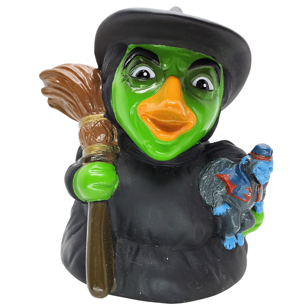 Figurine of a witch holding a broom and a small creature on a white background