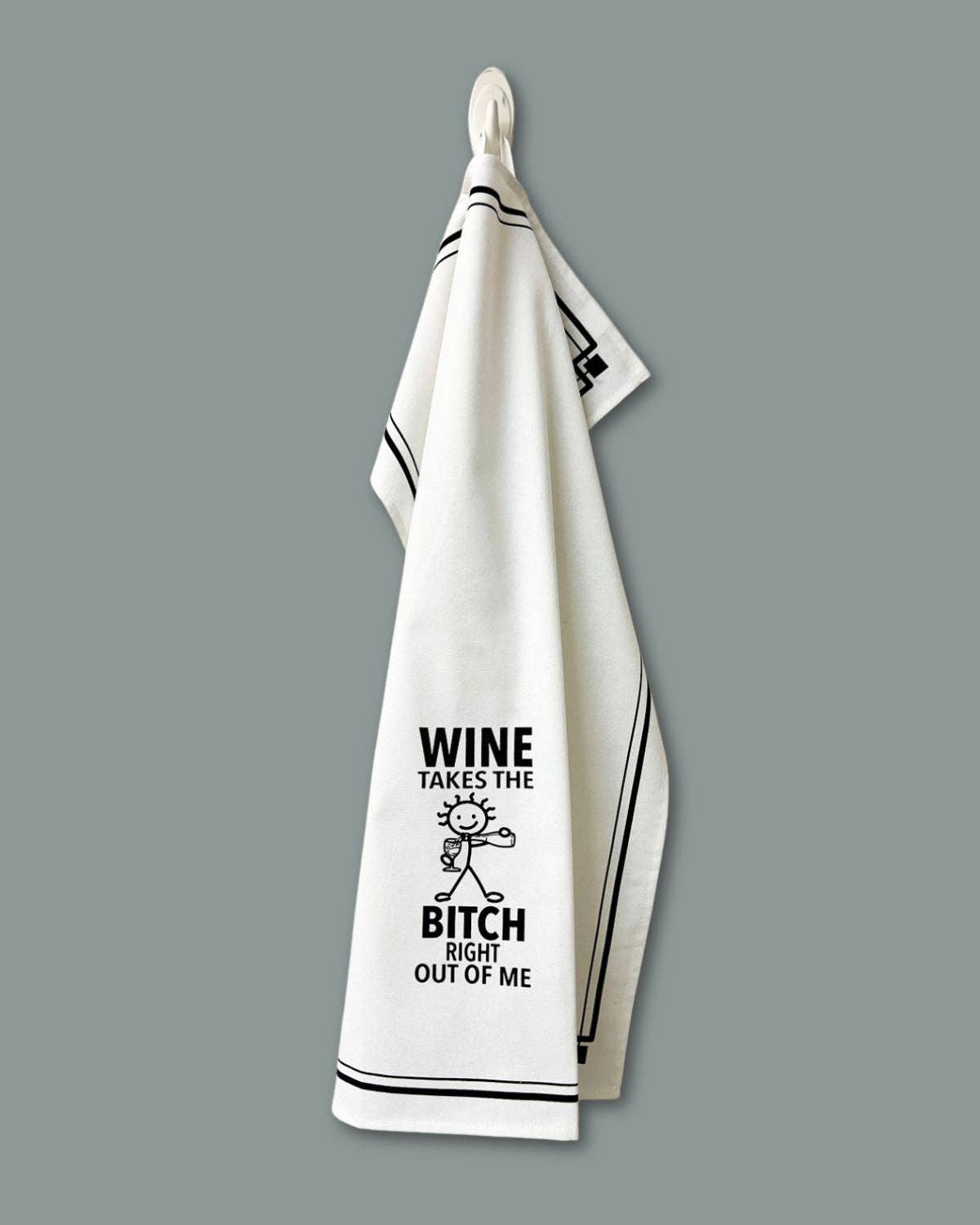 White towel with black text and graphic design on a gray background