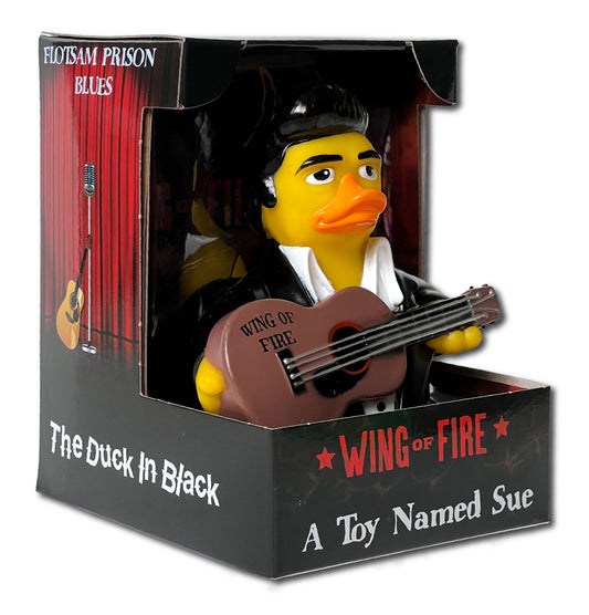 Rubber duck in a box with guitar and 'Wing of Fire' text, surrounded by packaging elements.