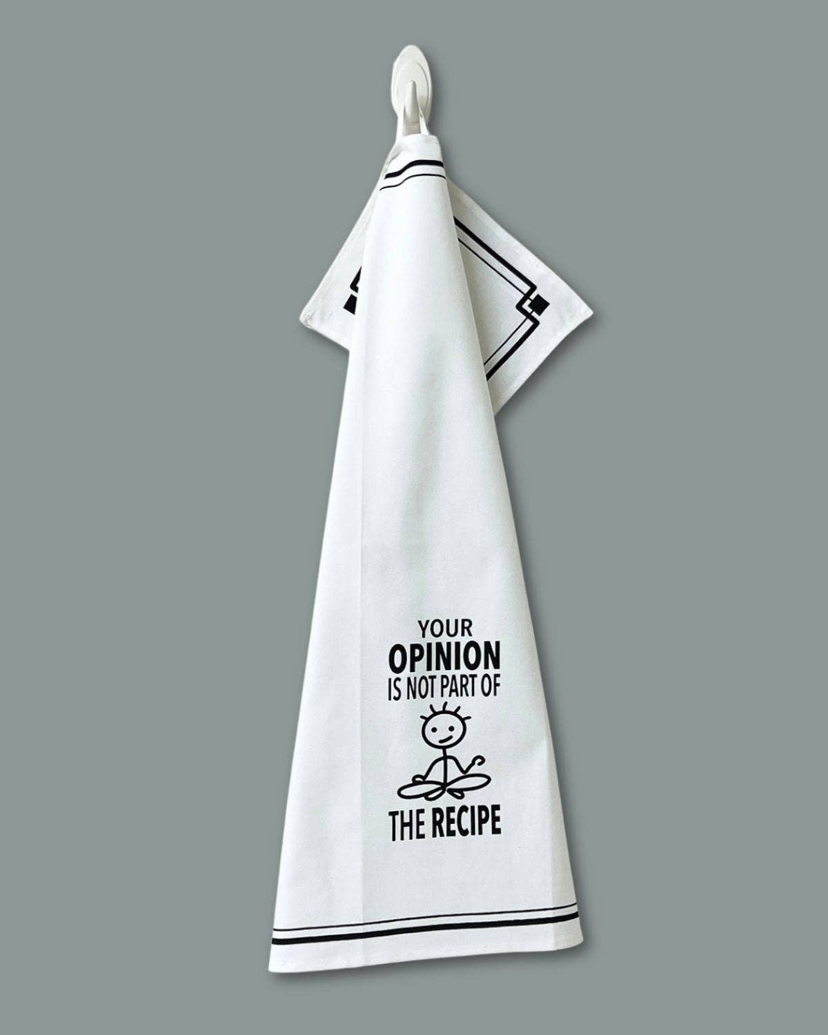 White towel with black text and graphic on a gray background