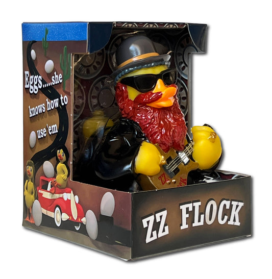 Toy duck in a leather outfit with sunglasses and guitar, in a decorative box with text and graphics.