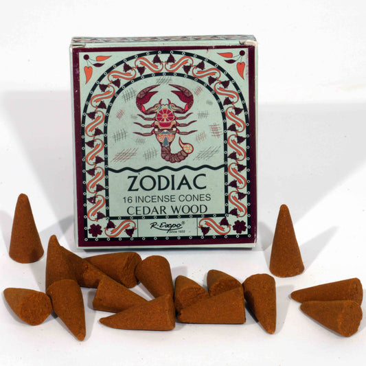 Box of zodiac incense cones with a scorpion design, surrounded by cedar wood incense cones on a white background.